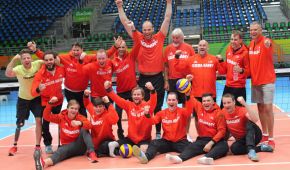Die deutschen Sitzvolleyball-Männer jubeln beim Gruppenphoto und freuen sich auf die Wettkämpfe.